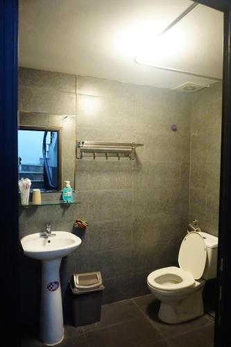 a bathroom with a toilet and a sink at Nusmile's Hostel and Travel in Hanoi