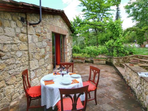 a table and chairs sitting on a patio at Belvilla by OYO Villa Valardegna in Montepulciano