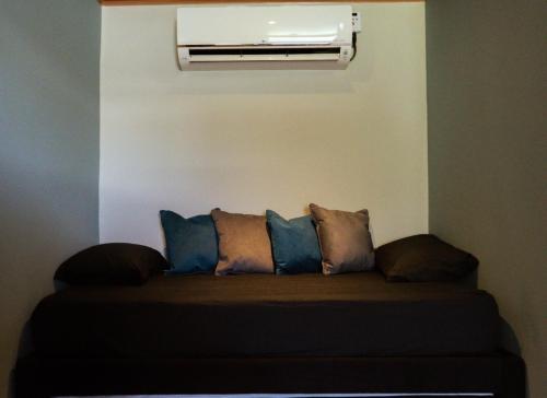 a couch with pillows in a room with a heater at Miss Anto´s Place-MAP in San Andrés