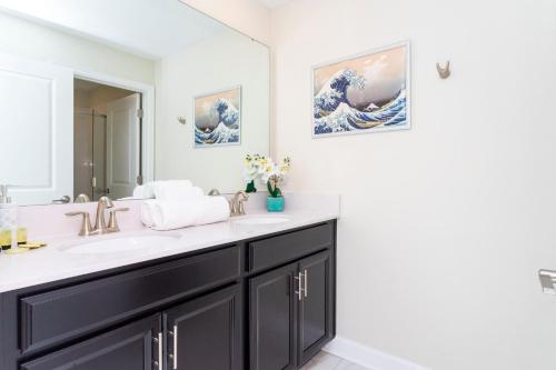 a bathroom with a sink and a mirror at Gorgeous 4Bd Close to Disney w/ Pool @ Champions Gate Resort 1196 in Davenport