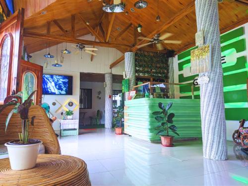 a lobby of a store with plants and a counter at Infinite Green Pension in Puerto Princesa City