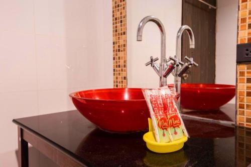 a bathroom with a red bowl and two faucets at The Main Event in Pattaya South