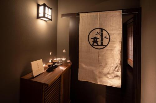 a bathroom with a curtain with a sign on it at Dotonbori no Yado Konjakuso - Vacation STAY 26587v in Osaka