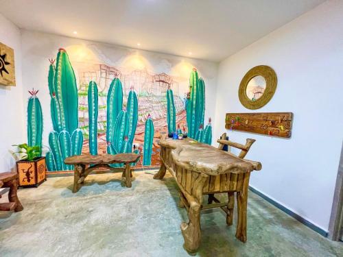 a room with a mural of cacti on the wall at Hotel Anauco in Bucaramanga