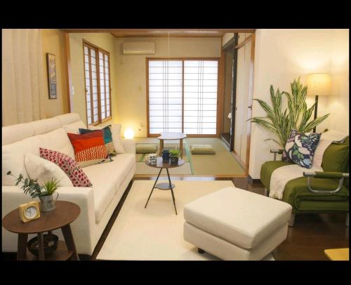a living room with a couch and a table at They are NOT HOUSE - Vacation STAY 86998 in Okinawa City