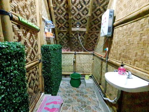 a small bathroom with a sink and a toilet at Argapuri Jungle Resort Ciwidey in Ciwidey