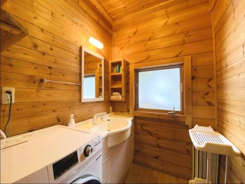 a bathroom with a sink and a stove in it at Swiss Chalet - Vacation STAY 11450v in Iida