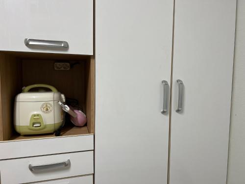 a kitchen cabinet with a toaster in a drawer at Sangmin suite in Daejeon