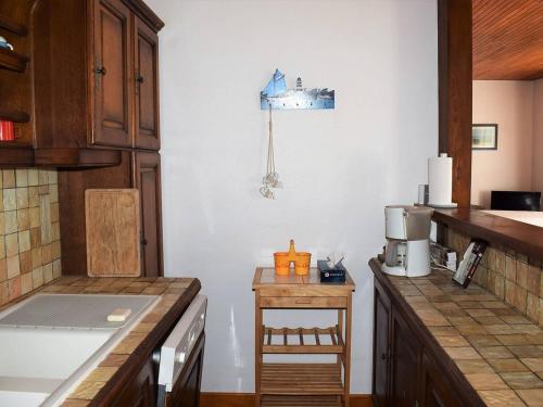 トレガステルにあるMaison Trégastel, 4 pièces, 6 personnes - FR-1-368-106の白い壁と木製のカウンタートップが備わるキッチン