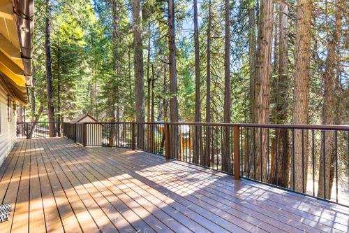 a wooden deck with a fence and some trees at Jug Handle Hideaway in Arnold