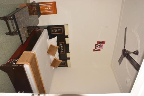 a hallway with a stairway with a clock on the wall at Hotel Holiday in Bharatpur