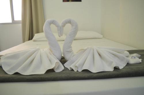 two swansuitsrendered to look like they are towels at Hotel Diamante Negro in Salvador