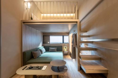 a small house with a staircase leading to a bedroom at NOA Hotel SHENZHEN LUOHU in Shenzhen