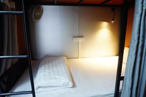 a small room with a bed in a bunk bed at Nusmile's Hostel and Travel in Hanoi