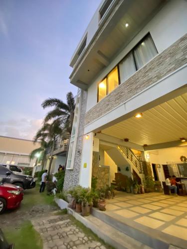 a house with a car parked in front of it at Pacific Waves Inn (Annex) in Baler