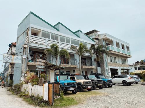 a large building with cars parked in front of it at Pacific Waves Inn (Annex) in Baler