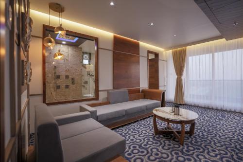 a living room with a couch and a table at Hotel Aditya Mansingh Inn in Somnath