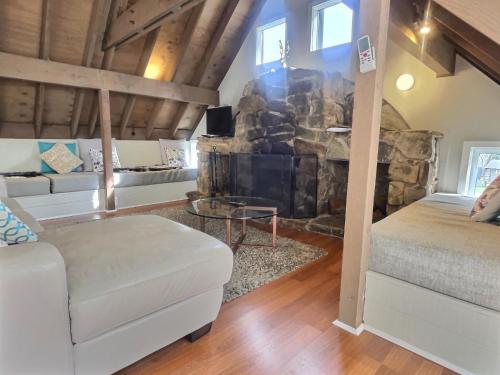 a living room with a stone wall at Meltdown, alpine-getaways in Dinner Plain