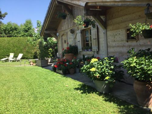 a house with potted plants in front of it at Chalet pour 2 amoureux in Allinges