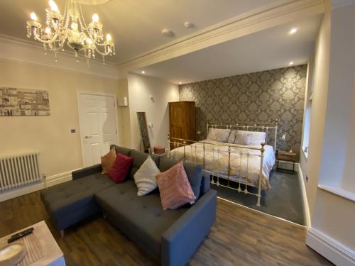 a living room with a couch and a bed at The Fort Lytham St Annes in Lytham St Annes