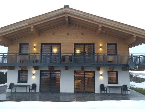 a house with a balcony on top of it at Ferienhaus Reiter Jochberg bei Kitzbühel in Jochberg