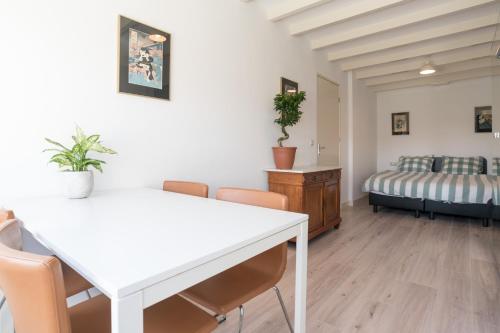 a living room with a table and chairs and a bed at Central Rooftop Terrace Guest Suite in Amsterdam