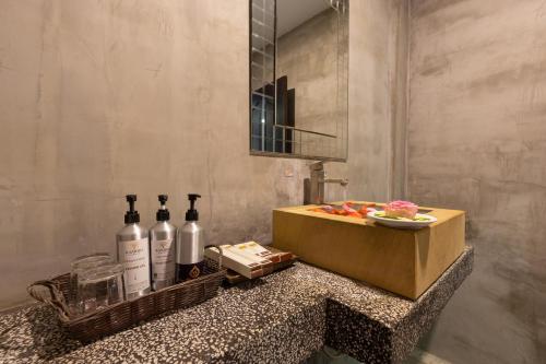 a bathroom with bottles of wine on a counter at The Five Senses Boutique Hotel in Siem Reap