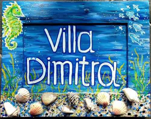 a blue sign with the words wild darters at Villa Dimitra in Mourteri