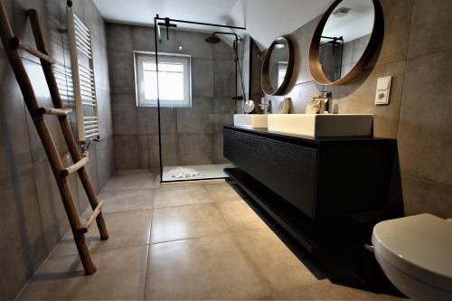 a bathroom with a sink and a mirror at Alpin Haus Berwang in Berwang