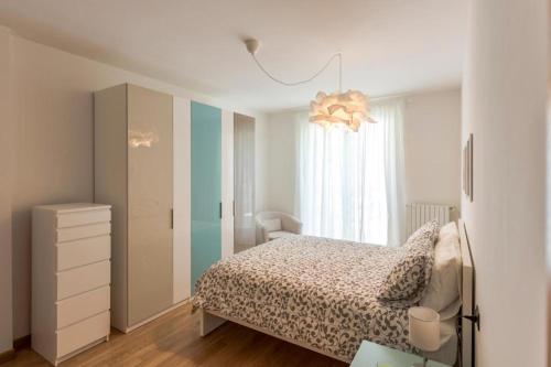 a bedroom with a bed and a dresser and a window at Residence Perlago in Predore