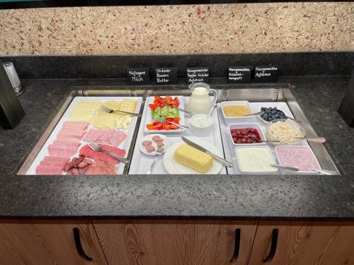 a counter top with different types of food on it at Ladestatthof in Neustift im Stubaital