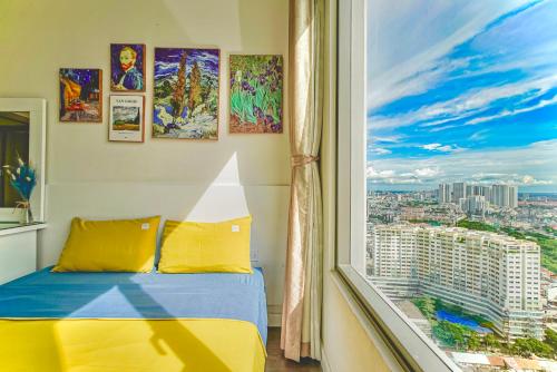 a bedroom with a view of a city from a window at GreenLine Service Aparts - Luxious, Heart of city in Ho Chi Minh City