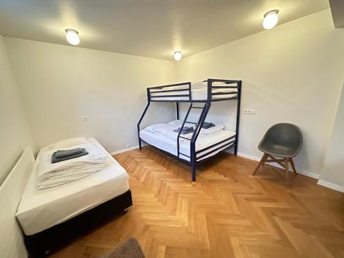 a room with two bunk beds and a chair at Big Villa centrally located in Reykjavik in Reykjavík