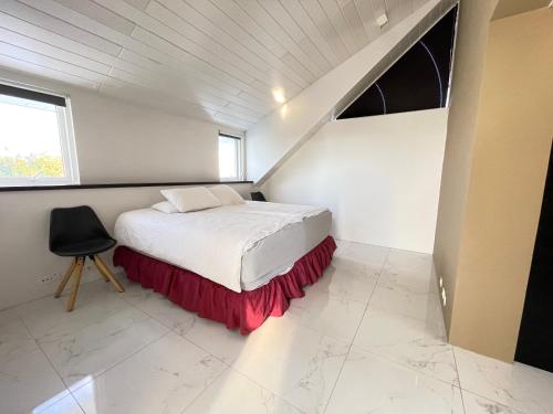 a bedroom with a bed and a chair in it at Big Villa centrally located in Reykjavik in Reykjavík