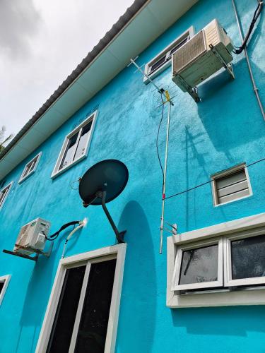a blue building with an air conditioner on it at Homestay D Paya Jauh in Temerloh