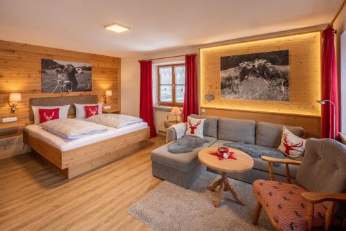 a living room with a couch and a bed at Allgäu-Moni in Füssen