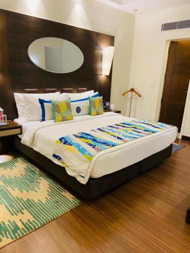 a bedroom with a large bed with a large mirror at Fortune Park Pushpanjali, Durgapur - Member ITC Hotels' Group in Durgāpur