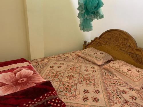 a bed with two pillows on top of it at Hello Super Hostel in Ella