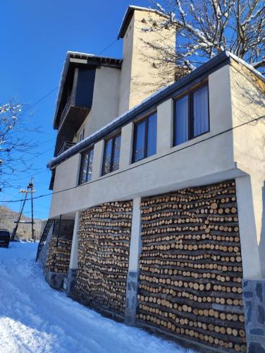a brick building with snow on the ground at Spardishi tower in Mestia