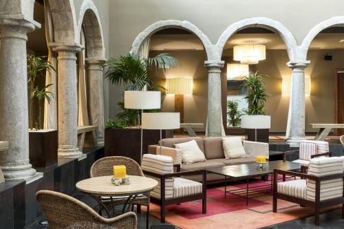 a lobby with a couch and chairs and tables at Parador De La Seu D'urgell in La Seu d'Urgell