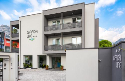 a white building with the words grand life on it at Garda Life in Riva del Garda