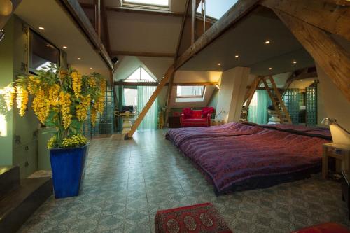 a large bedroom with a large bed and a vase of flowers at CubaCasa in Den Bosch