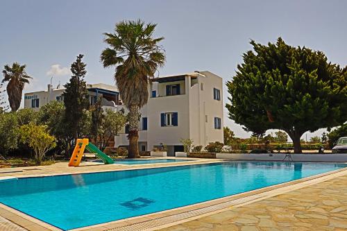 a swimming pool in front of a house at Manolis Studios in Kastraki Naxou