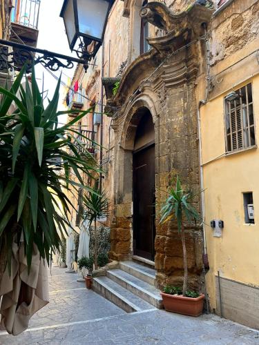 an entrance to a building with some plants in front at Vicoatenea in Agrigento