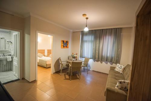 a living room with a couch and a table at Narcis Apart Hotel in Alanya