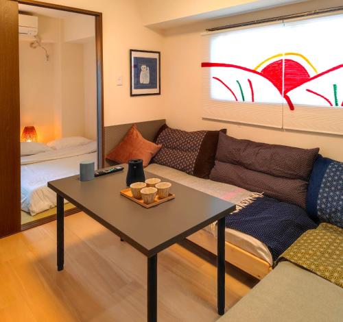 a living room with a couch and a table at ASAKUSAーHANAKAWADO in Tokyo