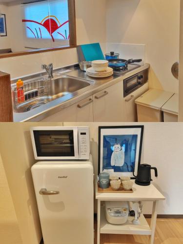 a kitchen with a white refrigerator and a microwave at ASAKUSAーHANAKAWADO in Tokyo