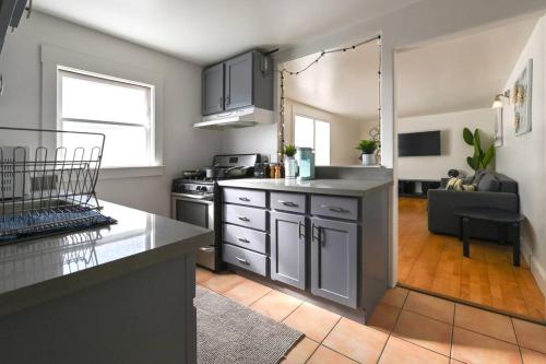 a kitchen with stainless steel appliances and a living room at Front House 3 bedroom flat nice street, walk to BART, shops in Berkeley