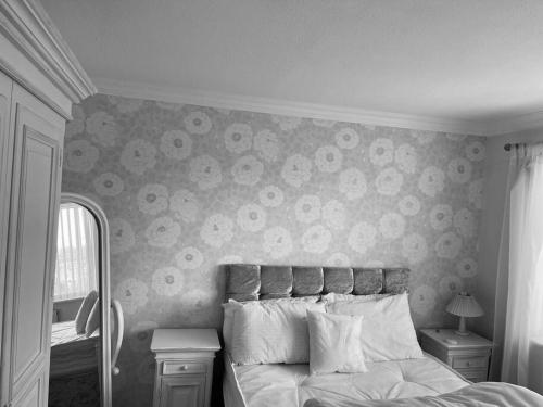 a black and white photo of a bedroom with a bed at Cosy 3-bed house in Hull
