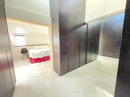 a bedroom with a bed and a glass wall at Big Villa centrally located in Reykjavik in Reykjavík